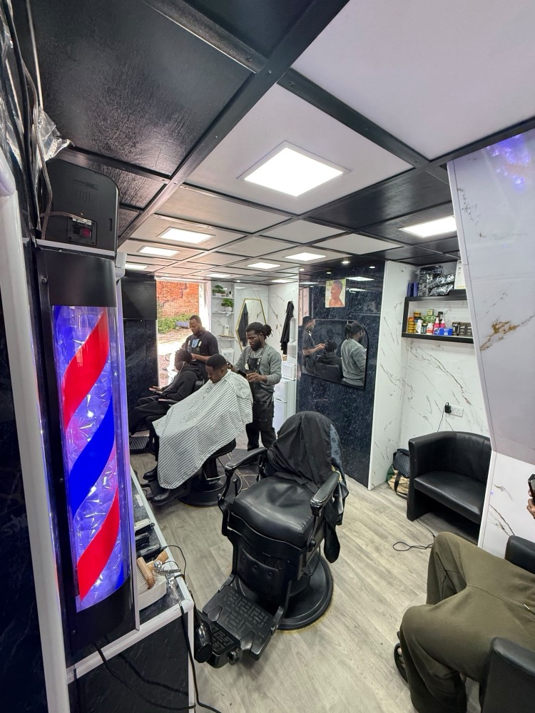 Inside Baba Yaro Barbers, looking down the room past the barber pole.